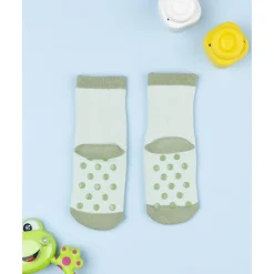 Calcetines antideslizantes de niño verdes con dinosaurio